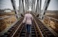 A member of the local administration allows the Yahad team to walk on the same bridge that the Jews were taken on en route to the shooting © Kate Kornberg/Yahad-In Unum