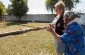 Yahad teams with an eyewitness to the shooting at the execution site. Today there is a stadium. The monument is not located on the mass grave. At this place about 480 Jews were shot in mid-August 1941. © Victoria Bahr/ Yahad-In Unum