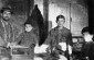 Photo of Avraham Frumer, his son and his apprentices in his workshop in prewar Turobin. ©Archive photo taken from Jewishgen.org