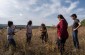 The Yahad-In Unum team with the witness at the location of the clay quarry. Today, it is a field. © Aleksey Kasyanov/Yahad-In Unum