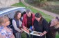 The Yahad-In Unum team with a Jewish survivor looking at the photos of the remaining Jewish heritage in Dzhuryn. ©Les Kasyanov/Yahad-In Unum