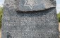 A monument with the inscription "Jewish cemetery in Bobrowniki, from the 2nd half of the 18th century. Cleaned in 1983-1984 with the efforts of Ignacy Bubis to commemorate the memory of his mother Chana who rests there." @Les Kasyanov/Yahad - In Unum