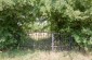 The entrance of the Jewish cemetery in Bobrowniki, which was cleaned and fenced with a hedge in the 80’s, after being destroyed during the war. @Les Kasyanov/Yahad - In Unum